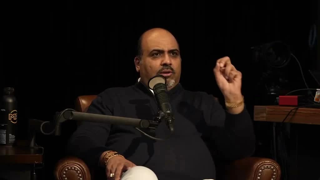 Jay Dhaliwal speaking into a microphone in the Mind Pump studio
